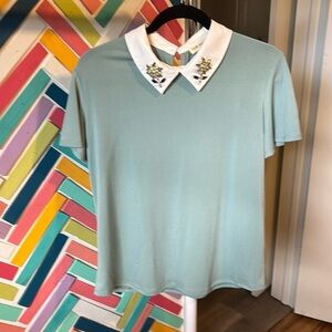 Flutter sleeve blouse with rhinestone detail on the collar.